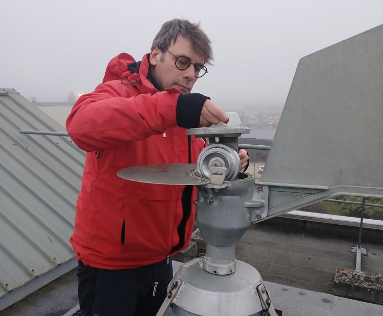 Technicien Atmo BFC mettant en place le dispositif de prélèvement pollens dans le capteur de Chalon-sur-Saône